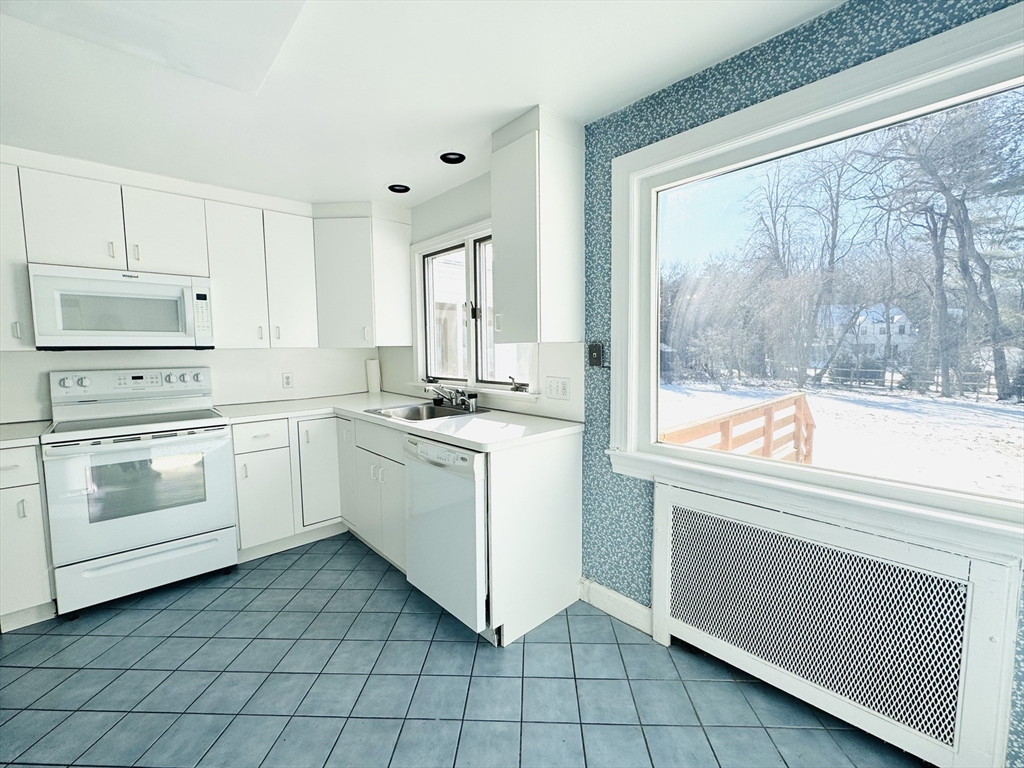 45 Beverly Road Brookline, MA 02467 - Photo 10 of 42 a white kitchen with a stove top oven and sink