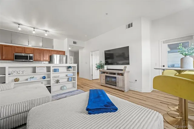 a room with a bed and flat tv screen