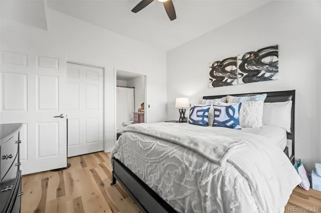 a bedroom with a bed and painting on the wall