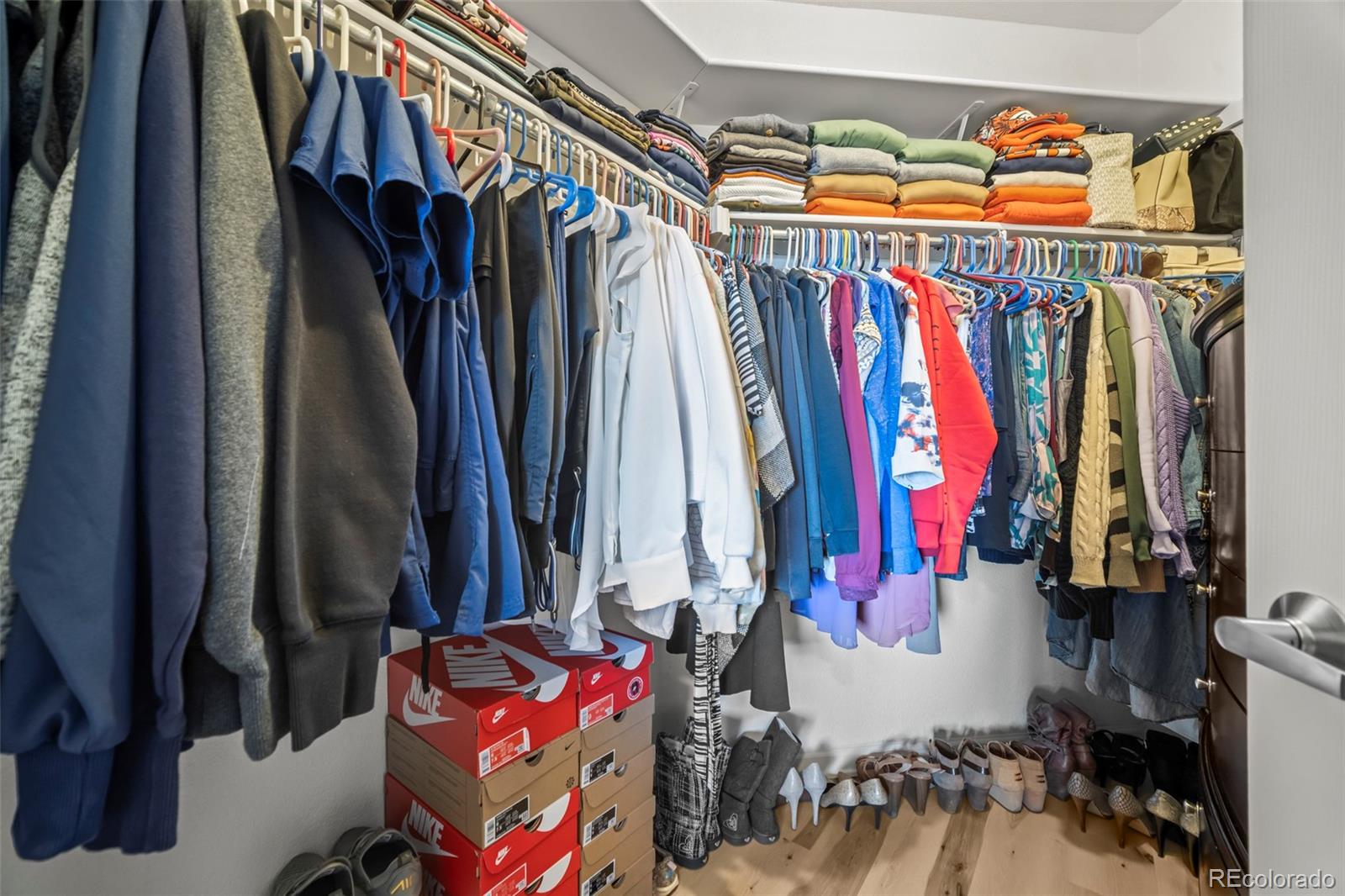 15475 Andrews Drive, Unit 307 Denver, CO 80239 - Photo 21 of 36 a view of walk in closet with clothes