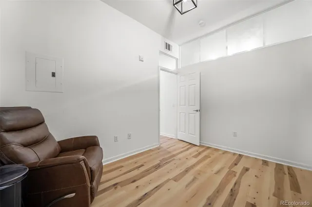 a room with wooden floor and furniture