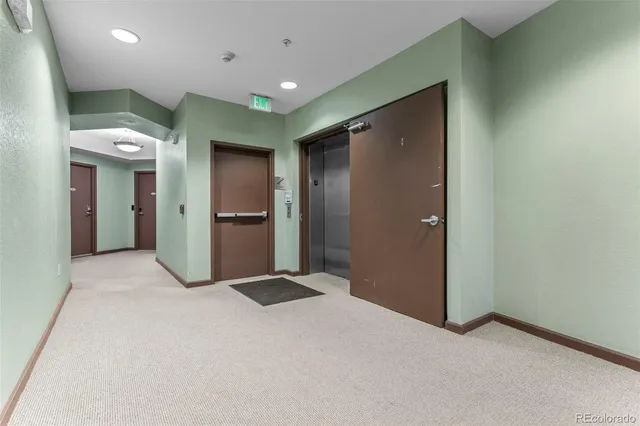 an empty room with closet and wooden door