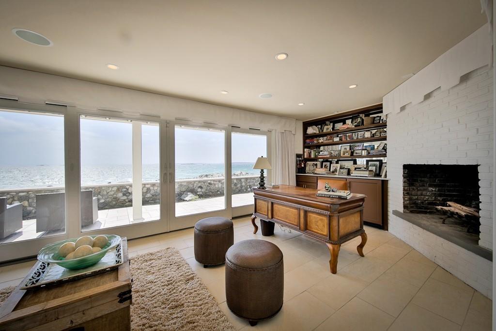 201 Ocean Avenue Marblehead, MA 01945 - Photo 17 of 21 a living room with furniture a flat screen tv and a floor to ceiling window