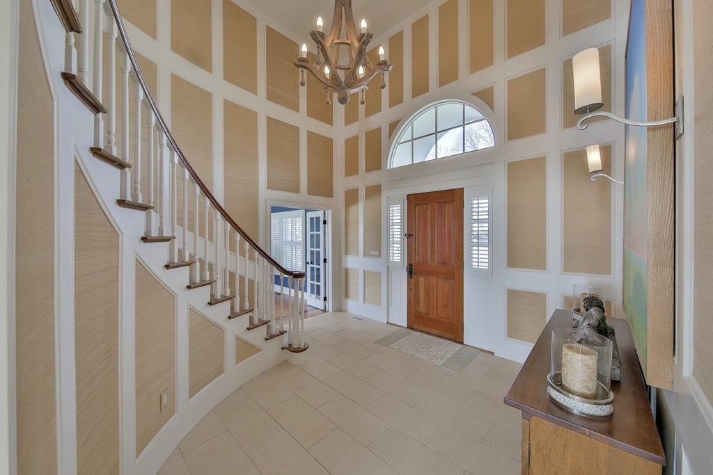 201 Ocean Avenue Marblehead, MA 01945 - Photo 19 of 21 a view of staircase with lots of frames on wall and a chandelier