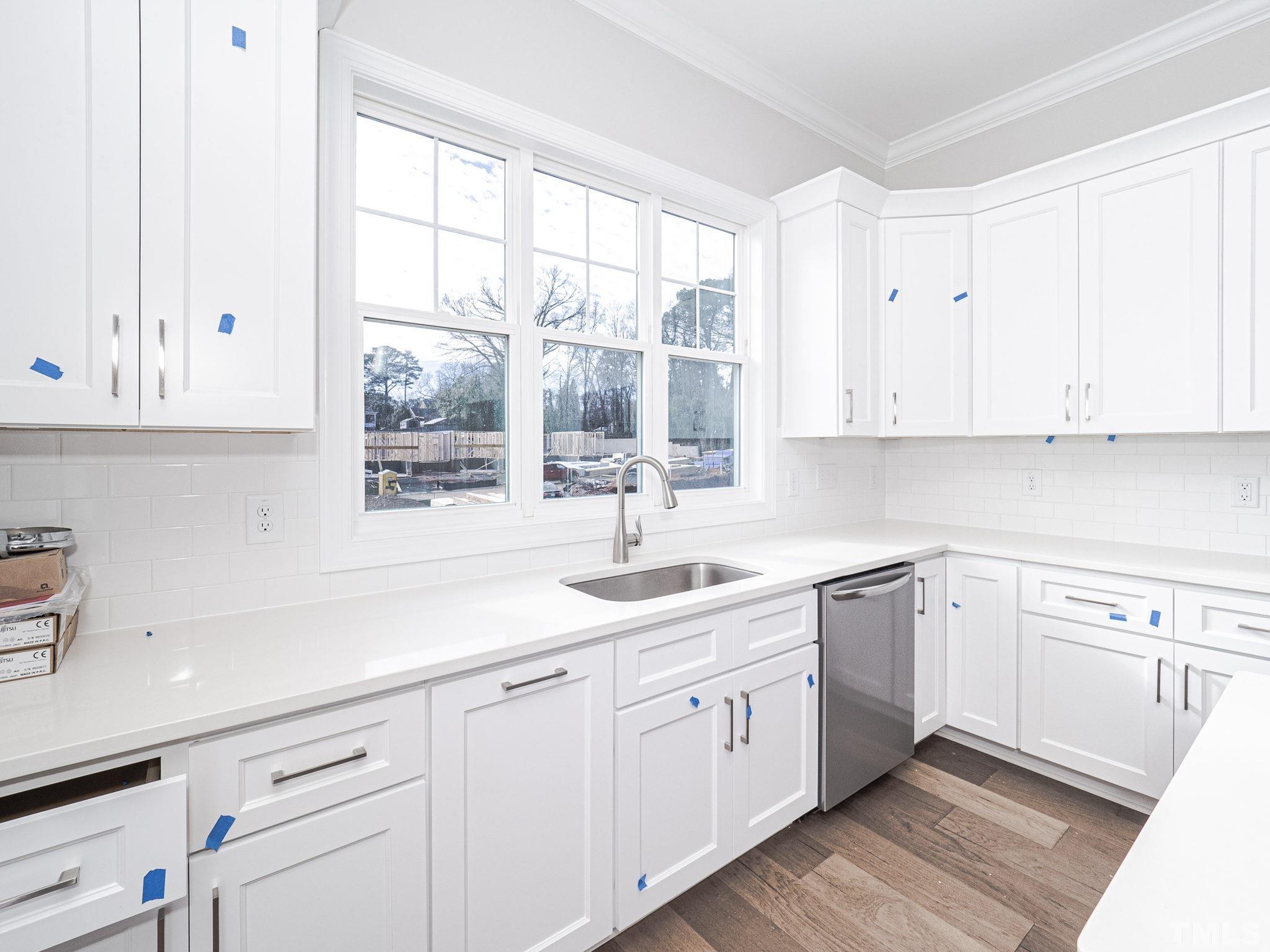 4922 Trek Lane Raleigh, NC 27606 - Photo 13 of 28 a kitchen with appliances cabinets and a sink