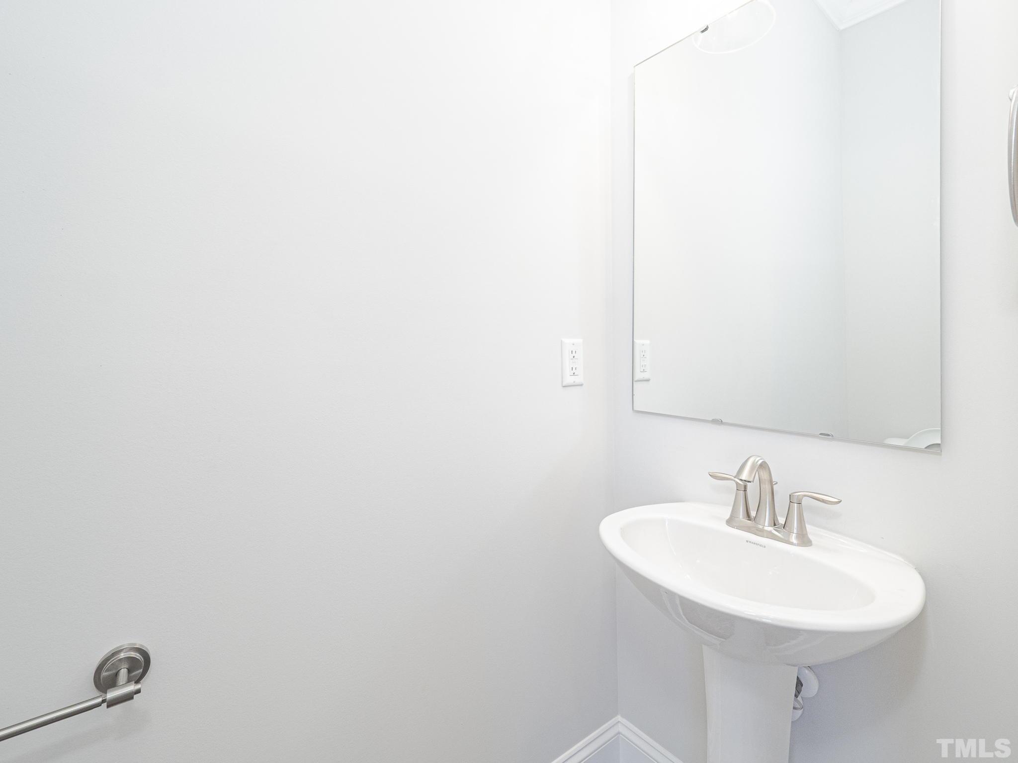 4922 Trek Lane Raleigh, NC 27606 - Photo 14 of 28 a bathroom with a sink and a mirror