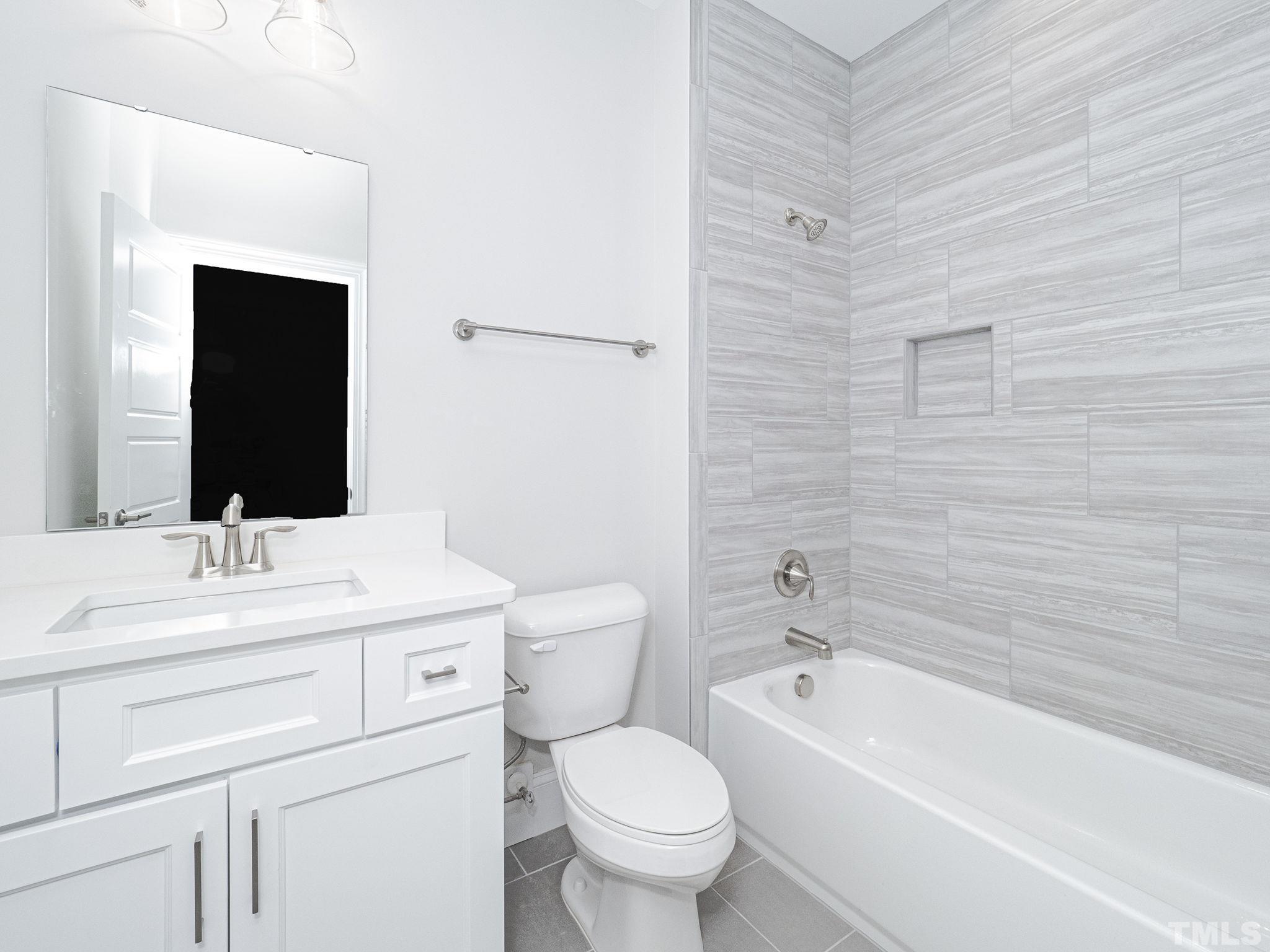4922 Trek Lane Raleigh, NC 27606 - Photo 19 of 28 a bathroom with a toilet sink and mirror