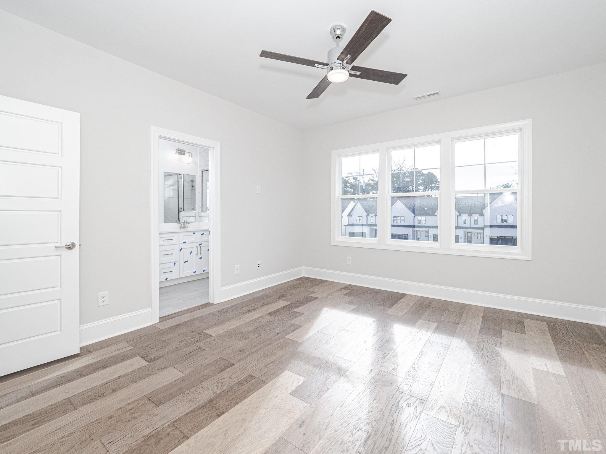 4922 Trek Lane Raleigh, NC 27606 - Photo 22 of 28 a view of an empty room with a window and wooden floor