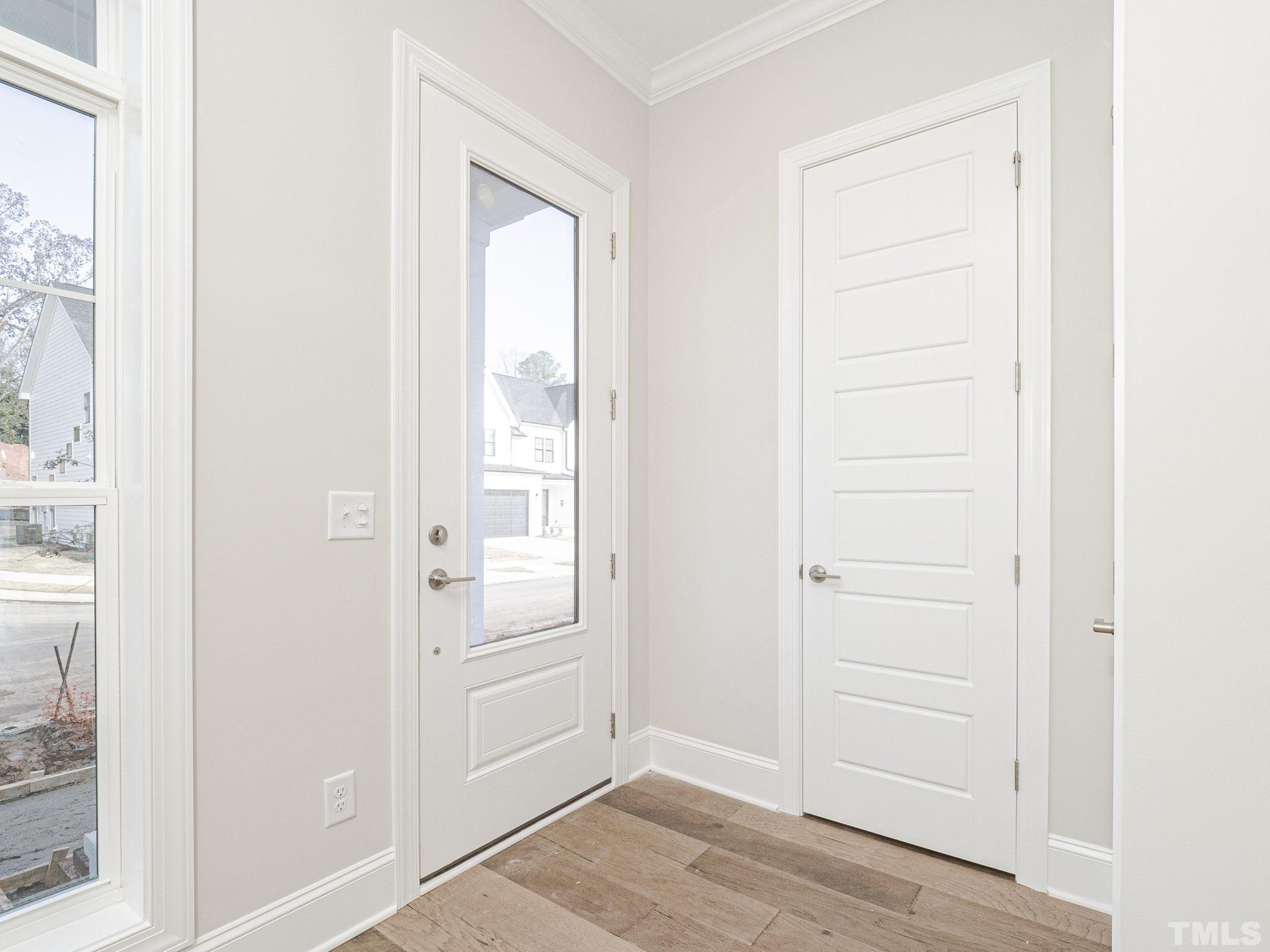 4922 Trek Lane Raleigh, NC 27606 - Photo 4 of 28 an empty room with windows cabinet and door