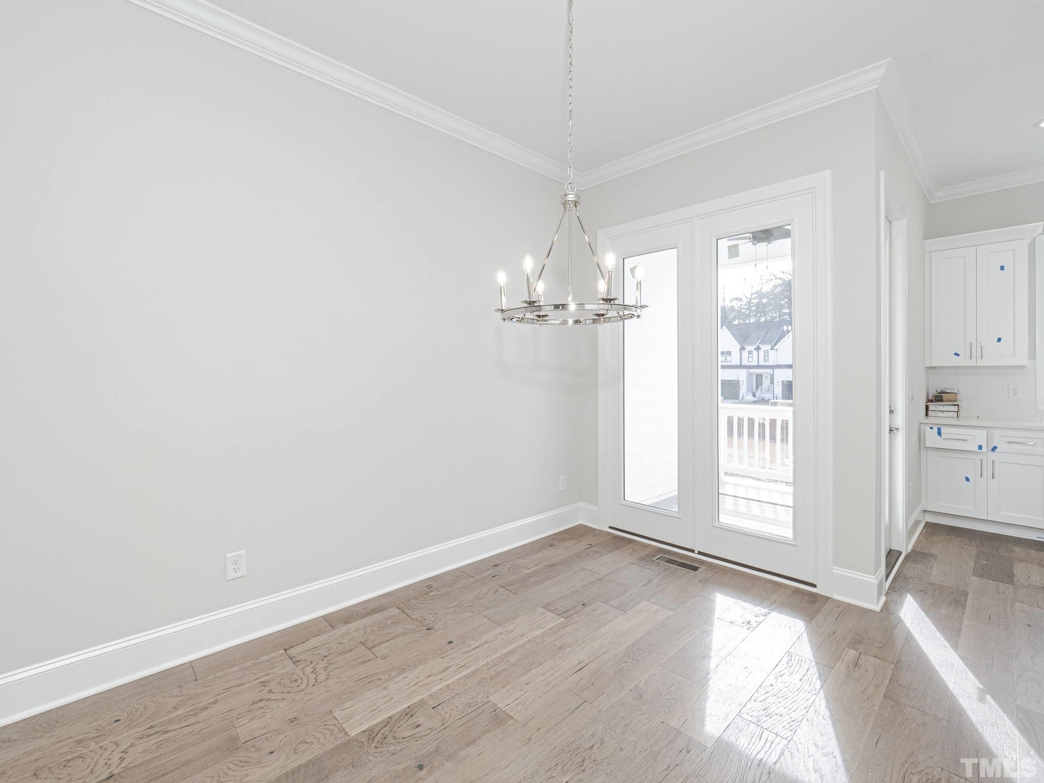 4922 Trek Lane Raleigh, NC 27606 - Photo 5 of 28 wooden floor in an empty room with a window