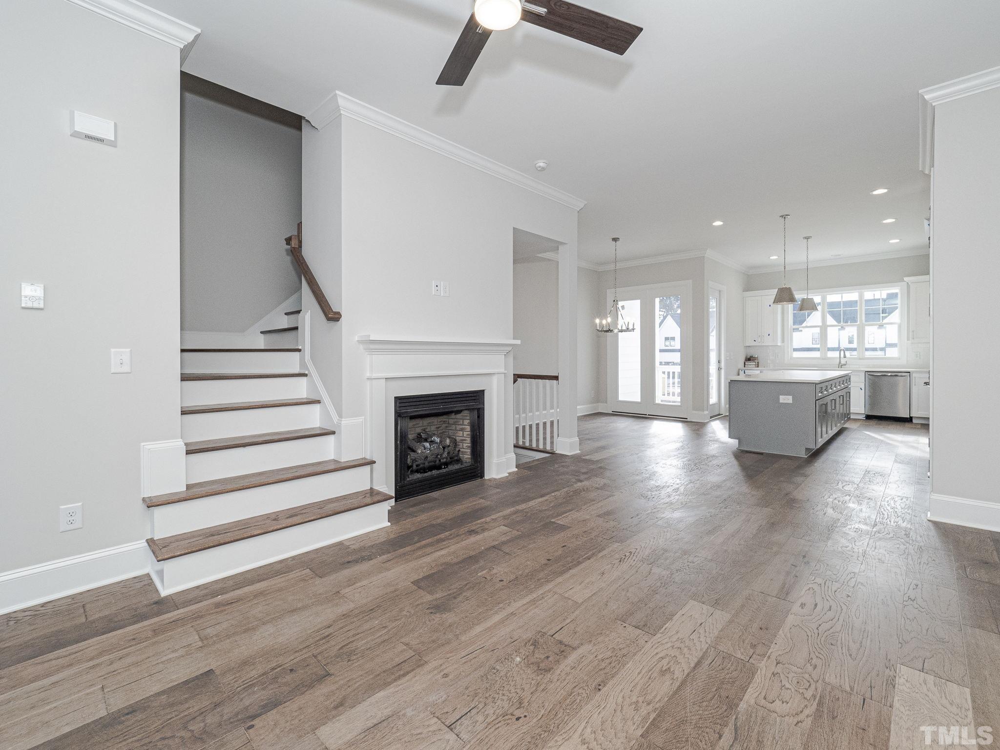 4922 Trek Lane Raleigh, NC 27606 - Photo 7 of 28 a view of a livingroom with wooden floor and a fireplace