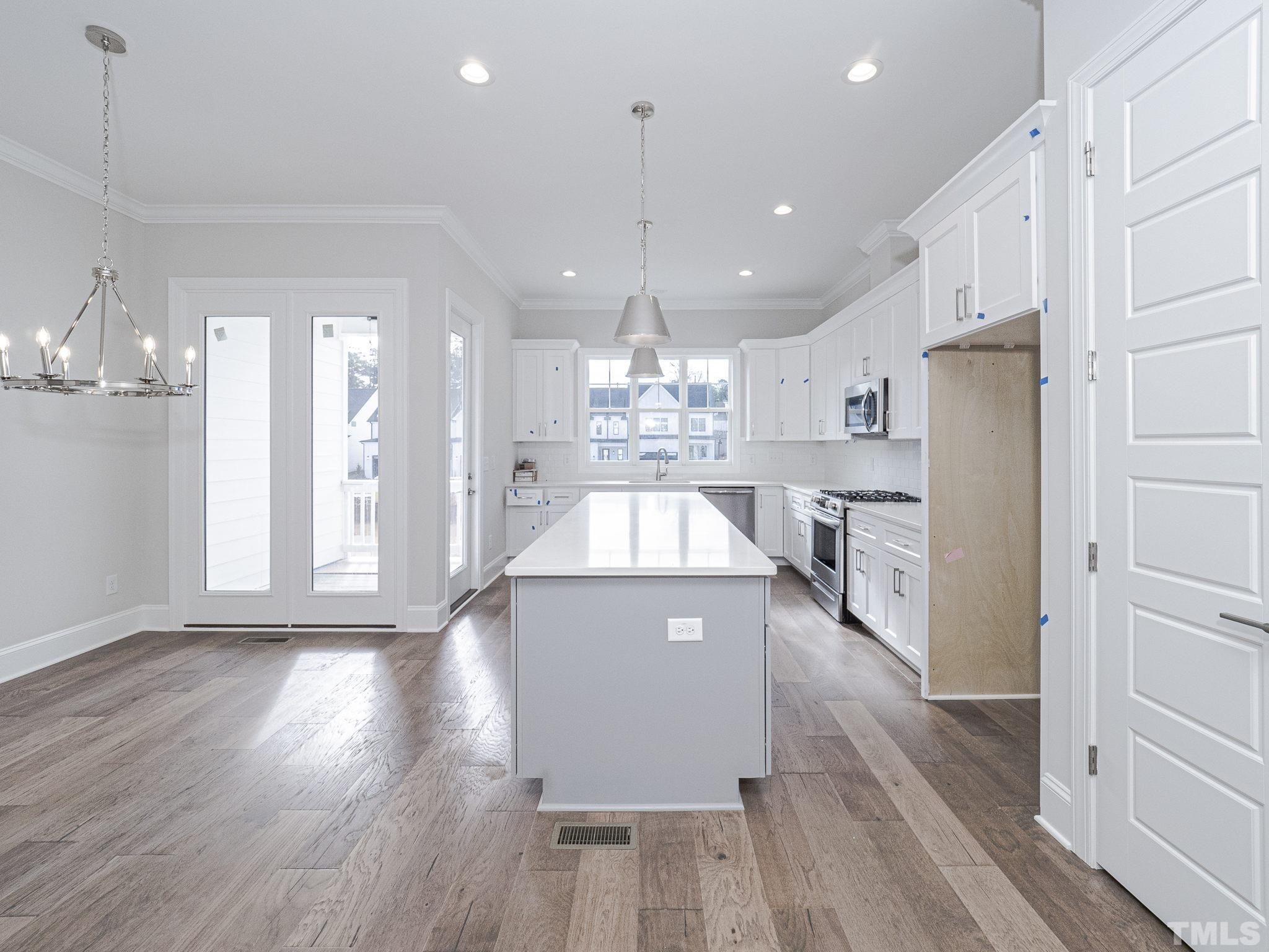 4922 Trek Lane Raleigh, NC 27606 - Photo 10 of 28 a view of a kitchen with cabinets stainless steel appliances and wooden floor