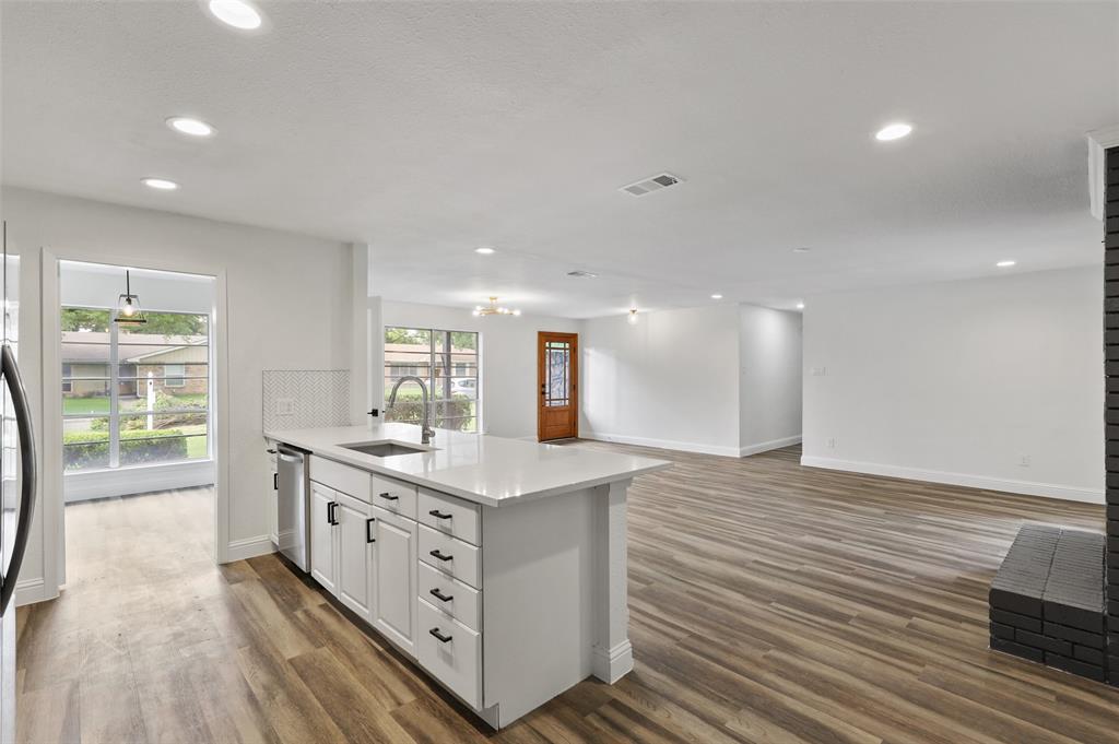 3126 Jubilee Trail Dallas, TX 75229 - Photo 5 of 38 a kitchen with stainless steel appliances granite countertop a sink stove and wooden floor