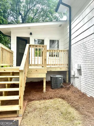 a view of balcony with a couple of cars parked in front of house