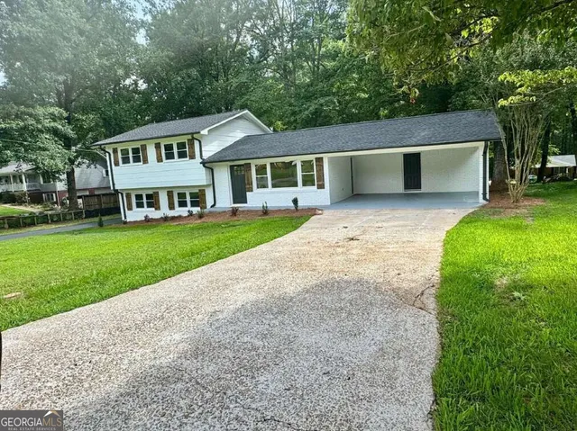 a front view of house with yard and green space
