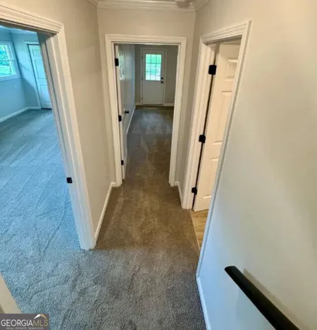 a kitchen with kitchen island granite countertop a stove and white cabinets with wooden floor