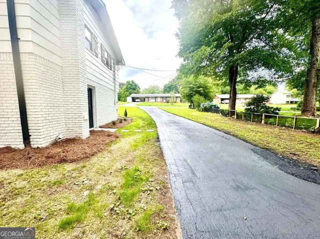 a view of a house with swimming pool and sitting area