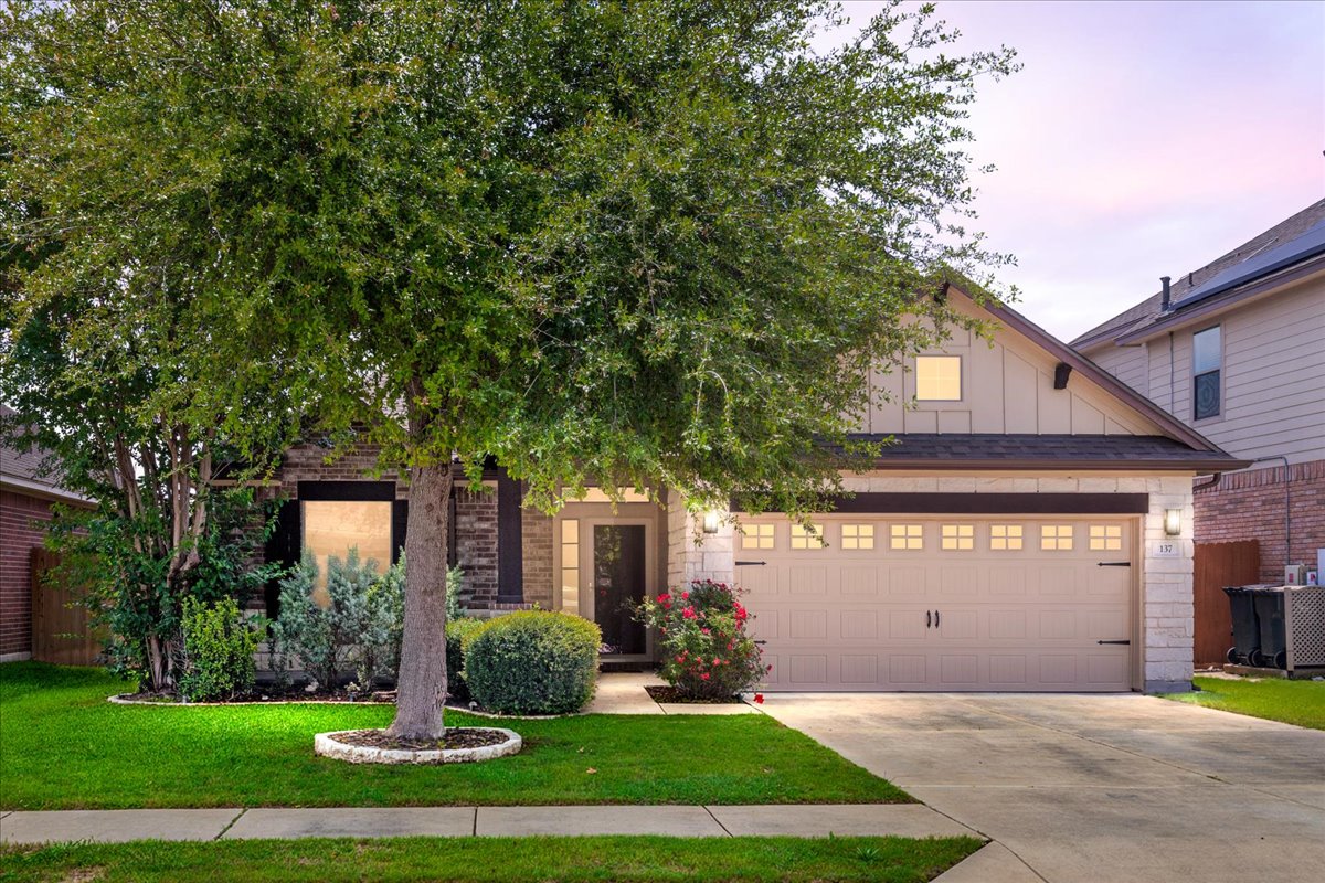 137 Navigator Drive Austin, TX 78717 - Photo 1 of 18 a front view of a house with a yard and garage