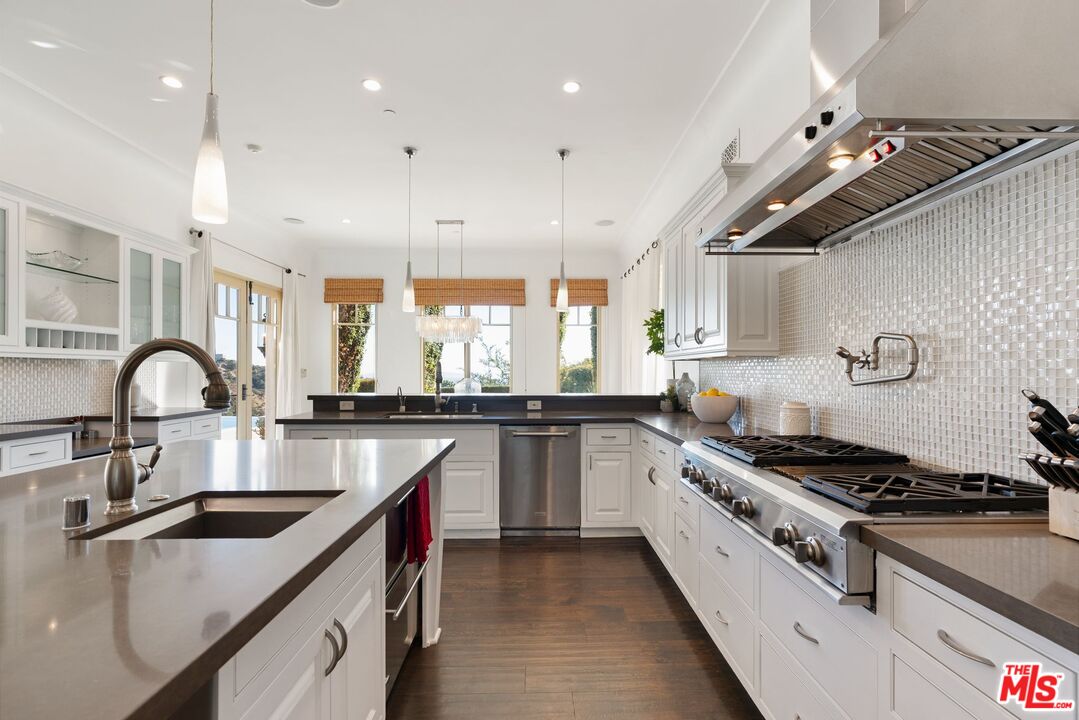 8 Beverly Ridge Terrace Beverly Hills, CA 90210 - Photo 20 of 74 a kitchen with kitchen island stainless steel appliances a sink a stove and a counter top space