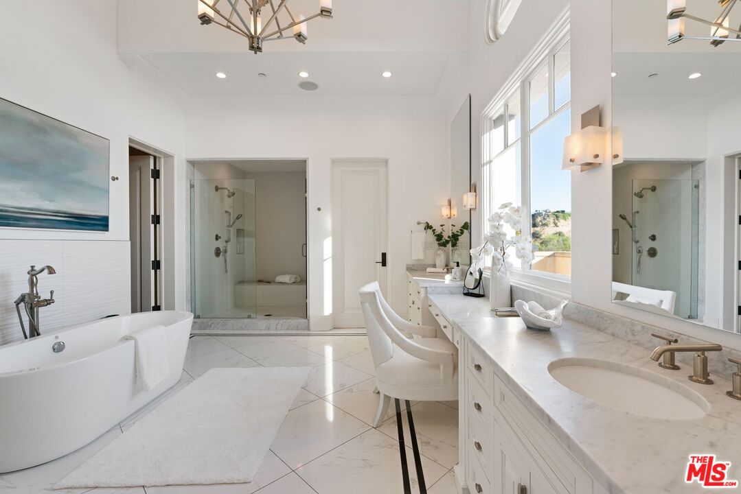 8 Beverly Ridge Terrace Beverly Hills, CA 90210 - Photo 33 of 74 a spacious bathroom with a granite countertop sink a mirror a bathtub and shower