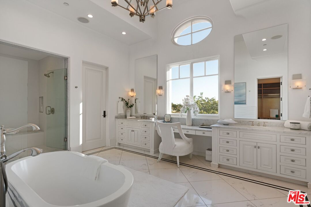 8 Beverly Ridge Terrace Beverly Hills, CA 90210 - Photo 35 of 74 a large bathroom with a double vanity sink a large mirror and a bathtub