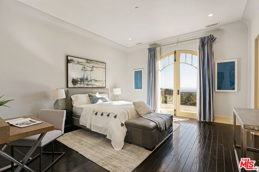 8 Beverly Ridge Terrace Beverly Hills, CA 90210 - Photo 51 of 74 a bed room with a bed a couch and a large window