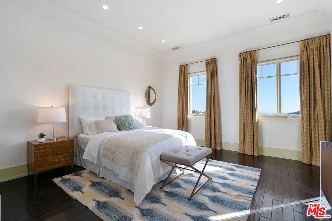 8 Beverly Ridge Terrace Beverly Hills, CA 90210 - Photo 53 of 74 a bedroom with a bed and wooden floor