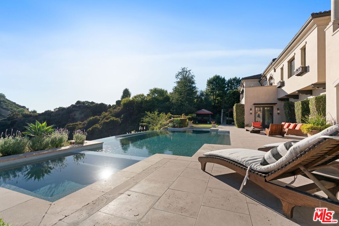 8 Beverly Ridge Terrace Beverly Hills, CA 90210 - Photo 55 of 74 a view of swimming pool with seating area and lake view