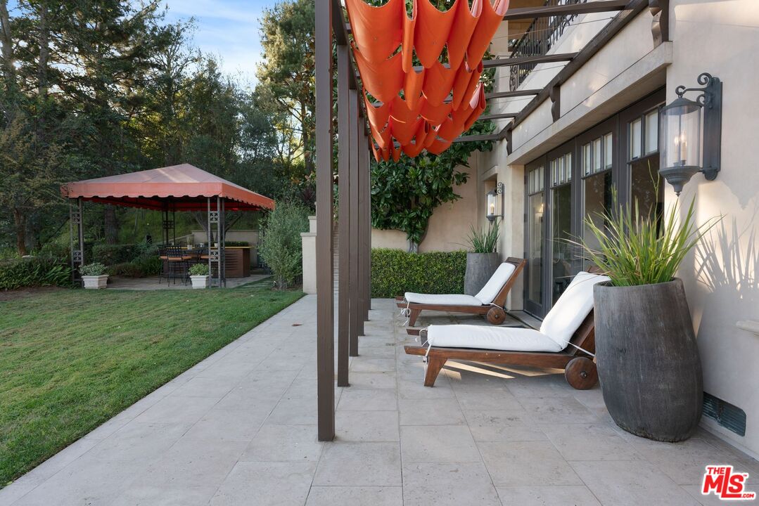 8 Beverly Ridge Terrace Beverly Hills, CA 90210 - Photo 57 of 74 a view of backyard with outdoor seating and wooden fence