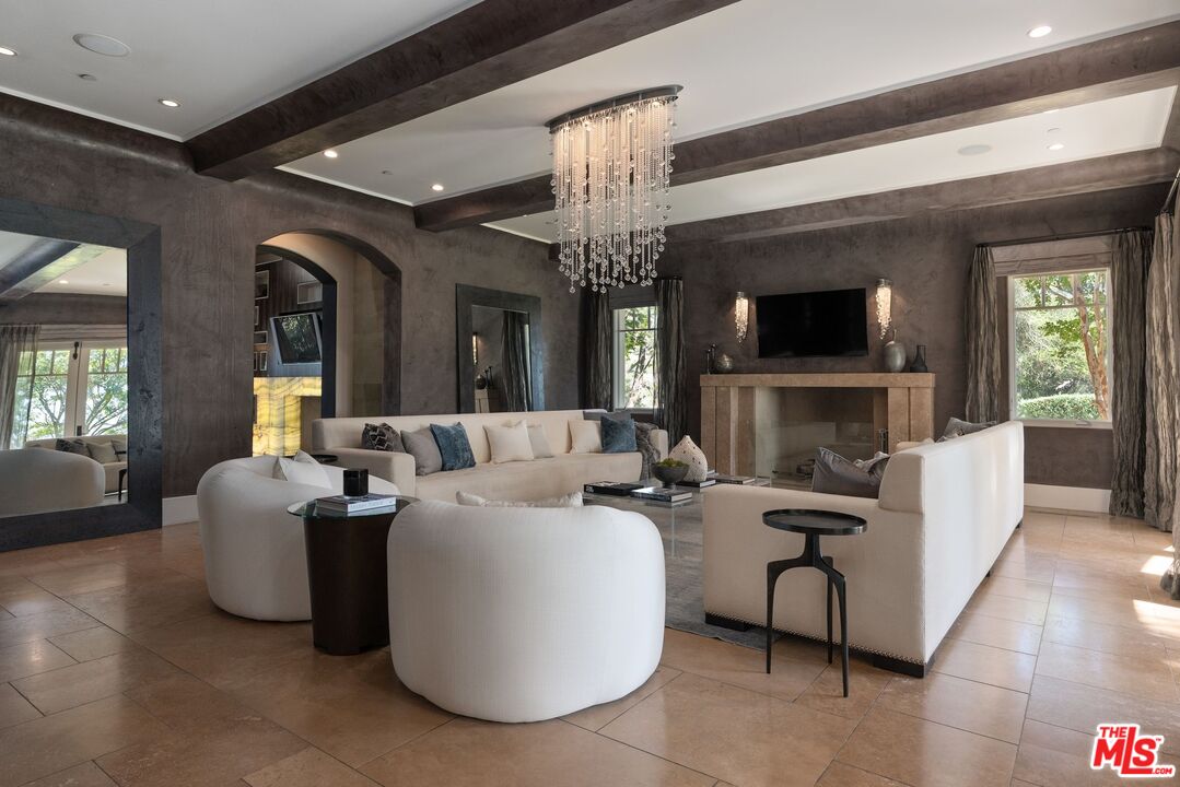 8 Beverly Ridge Terrace Beverly Hills, CA 90210 - Photo 6 of 74 a living room with fireplace furniture and a flat screen tv