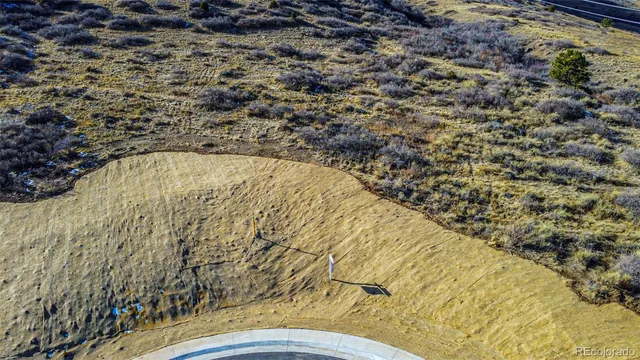 a view of a large building with mountains in the background