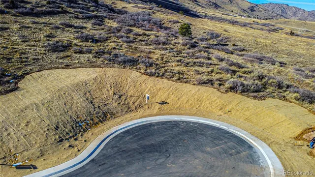 an aerial view of a houses with a yard