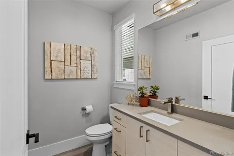 a kitchen with stainless steel appliances granite countertop a sink a stove a refrigerator cabinets and chairs