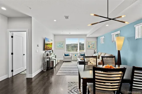 a kitchen with granite countertop white cabinets and stainless steel appliances