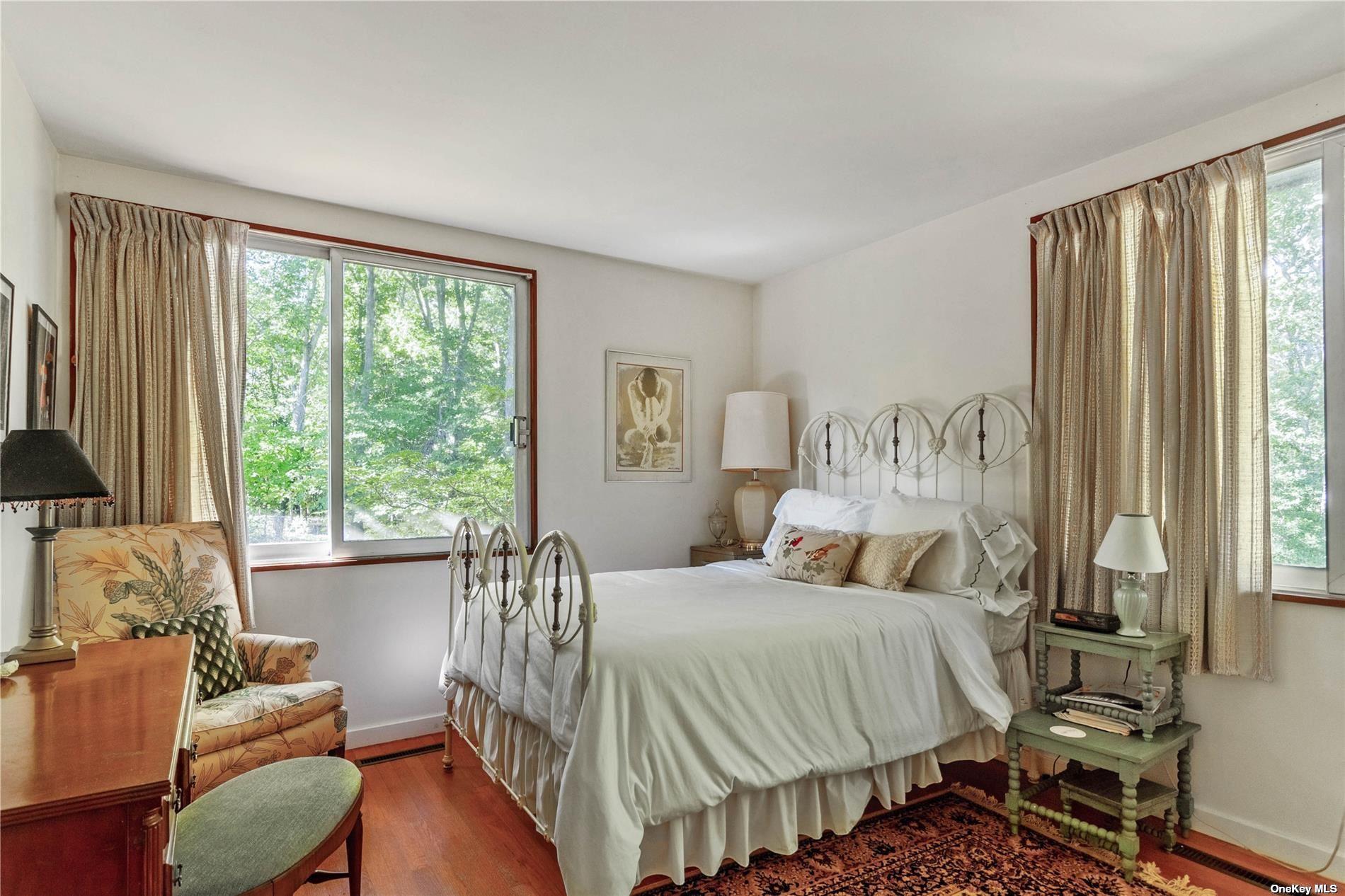 189 Old Harbor Road New Suffolk, NY 11956 - Photo 14 of 26 a bedroom with a bed and a couch