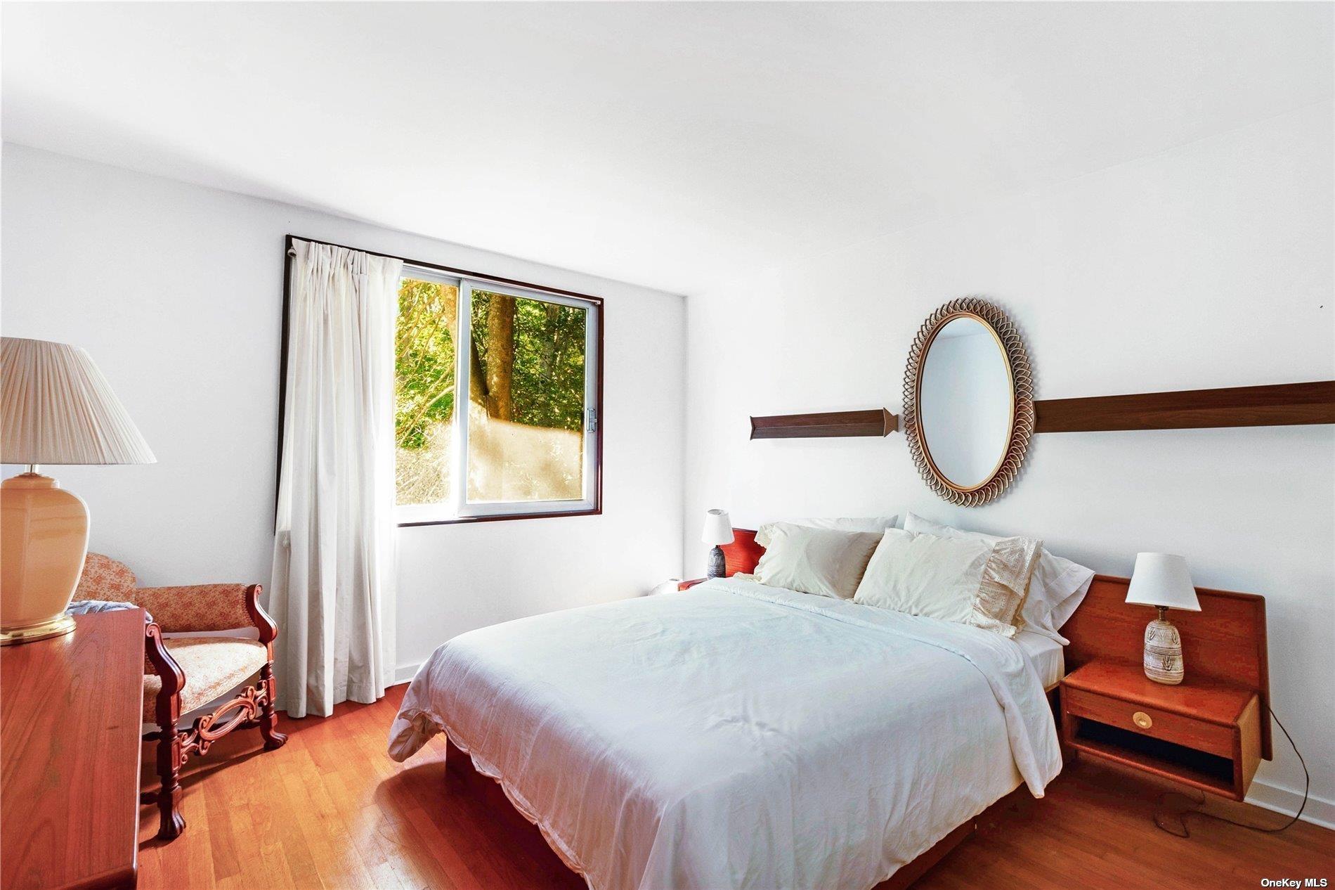 189 Old Harbor Road New Suffolk, NY 11956 - Photo 15 of 26 a bedroom with a bed and window