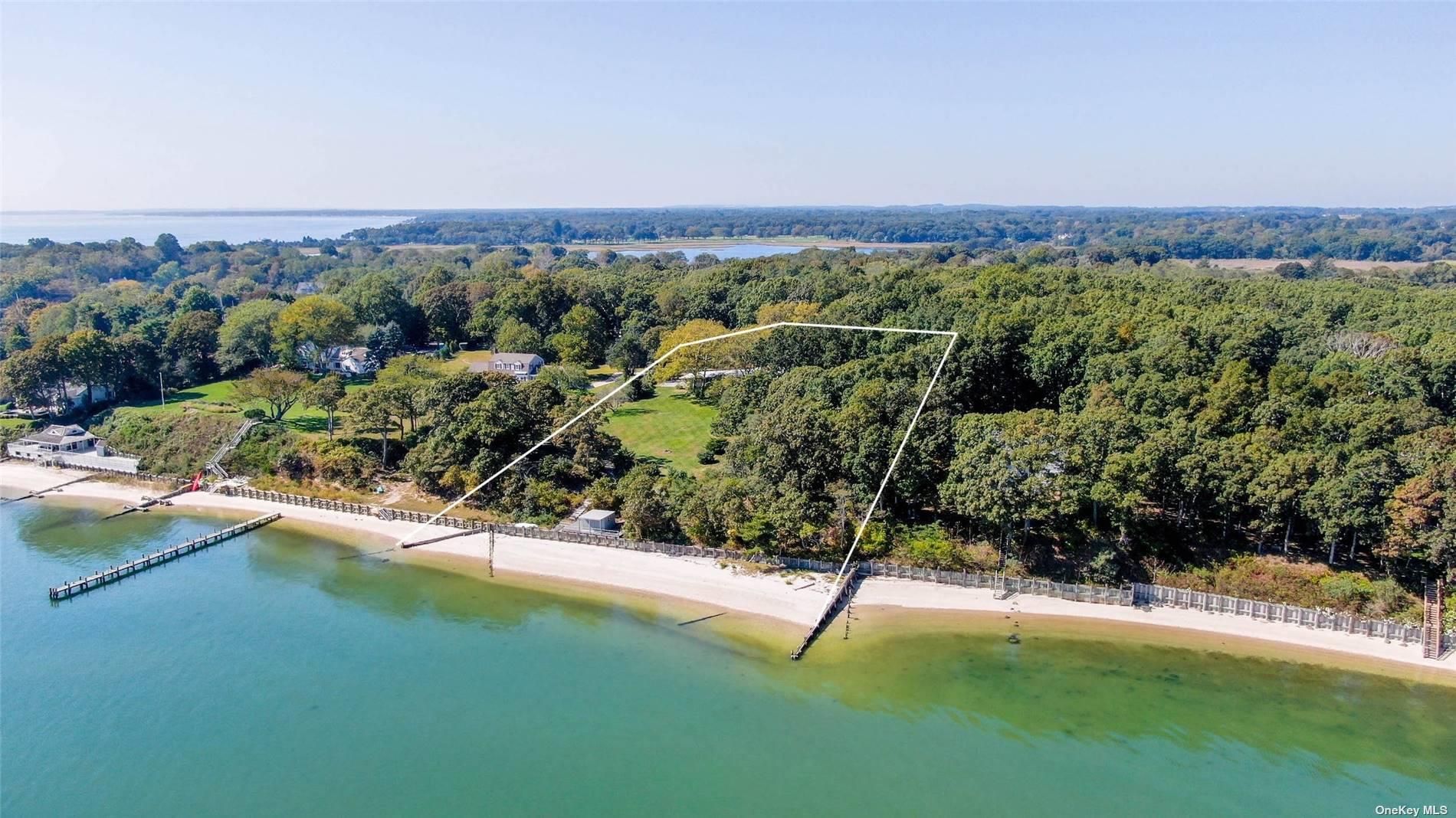 189 Old Harbor Road New Suffolk, NY 11956 - Photo 2 of 26 a view of a city with lush green forest