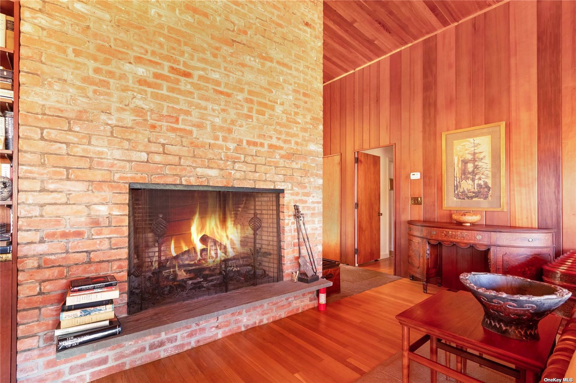 189 Old Harbor Road New Suffolk, NY 11956 - Photo 9 of 26 a room with furniture and a fireplace