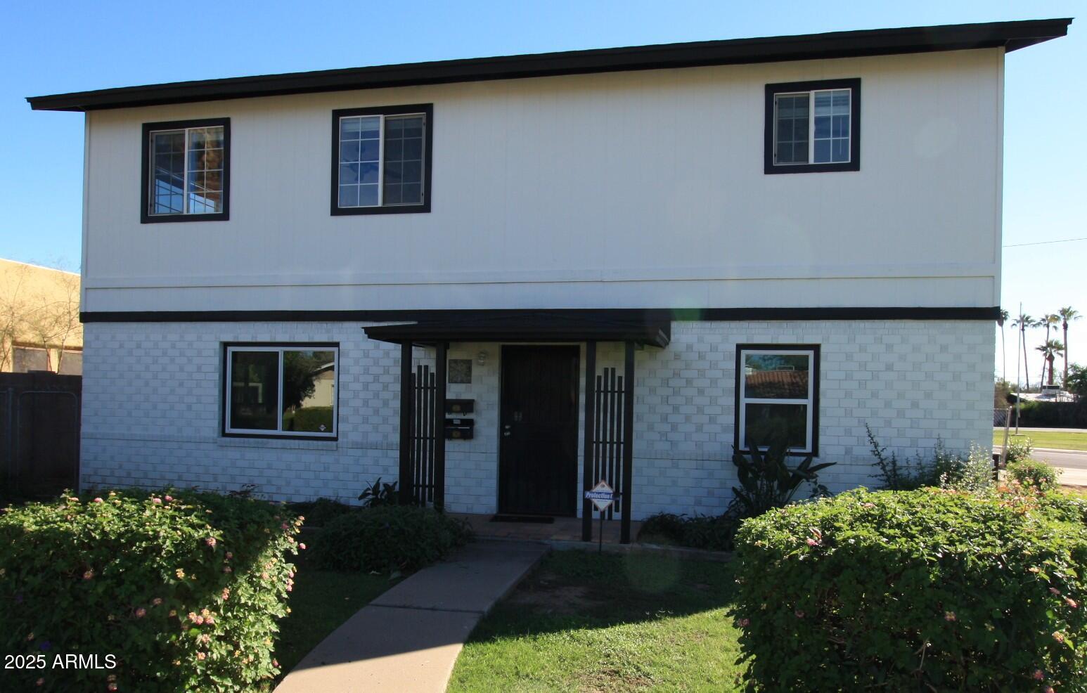 a front view of a house with garden