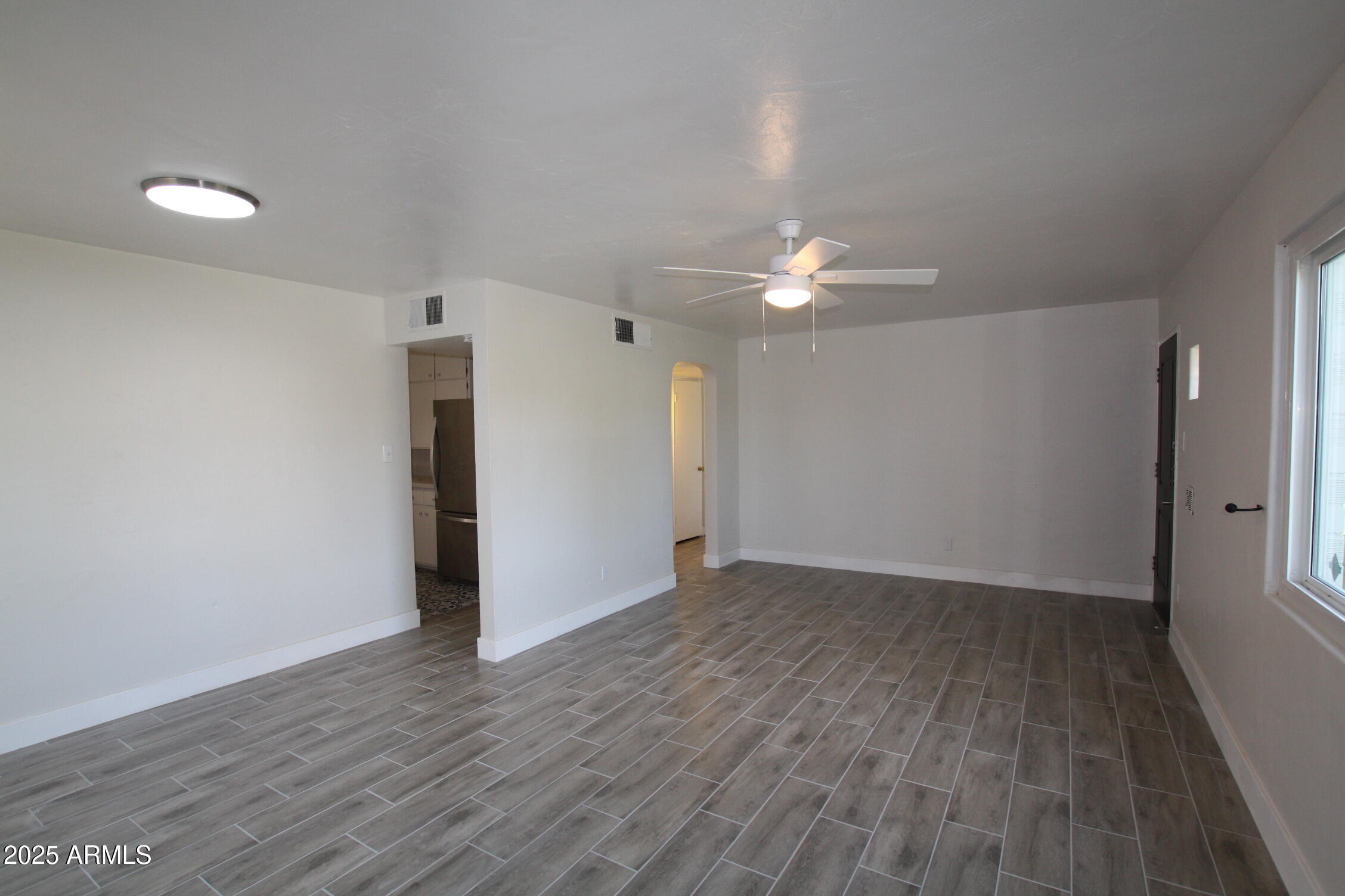 1333 East Flower Street Phoenix, AZ 85014 - Photo 11 of 20 a view of a room with wooden floor and a ceiling fan