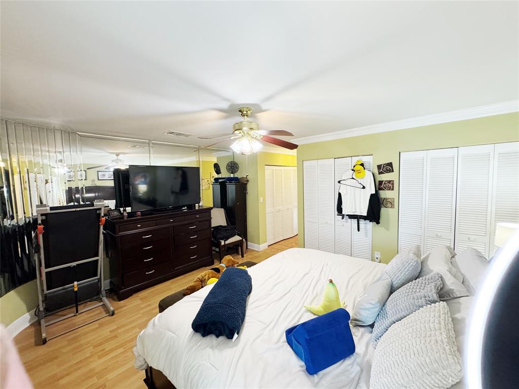 718 Southwest 88th Terrace, Unit 718 Plantation, FL 33324 - Photo 14 of 37 a bedroom with a bed and a flat tv screen on dresser