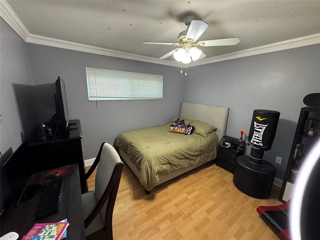 718 Southwest 88th Terrace, Unit 718 Plantation, FL 33324 - Photo 21 of 37 a bedroom with a bed window and a flat screen tv