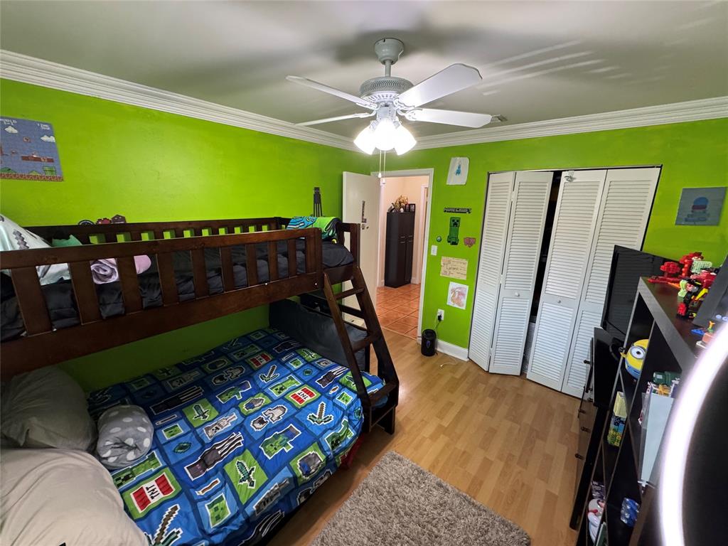 718 Southwest 88th Terrace, Unit 718 Plantation, FL 33324 - Photo 25 of 37 a bed room with furniture and a flat screen tv