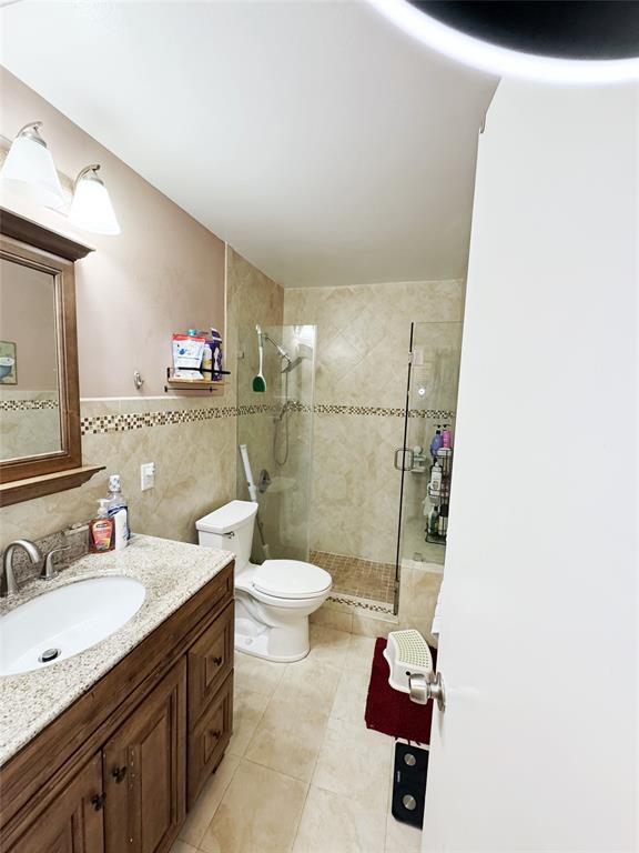 718 Southwest 88th Terrace, Unit 718 Plantation, FL 33324 - Photo 26 of 37 a bathroom with a granite countertop sink toilet and shower