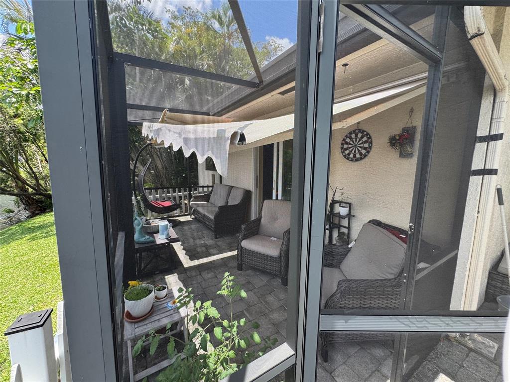 718 Southwest 88th Terrace, Unit 718 Plantation, FL 33324 - Photo 28 of 37 view of living room with patio