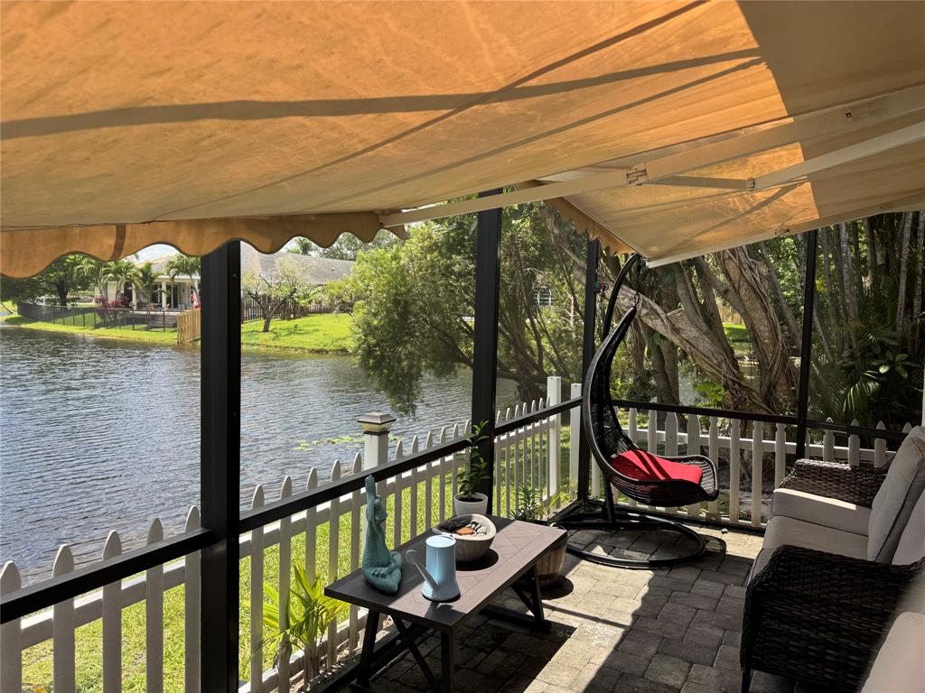 718 Southwest 88th Terrace, Unit 718 Plantation, FL 33324 - Photo 33 of 37 a view of a balcony with wooden floor and outdoor seating