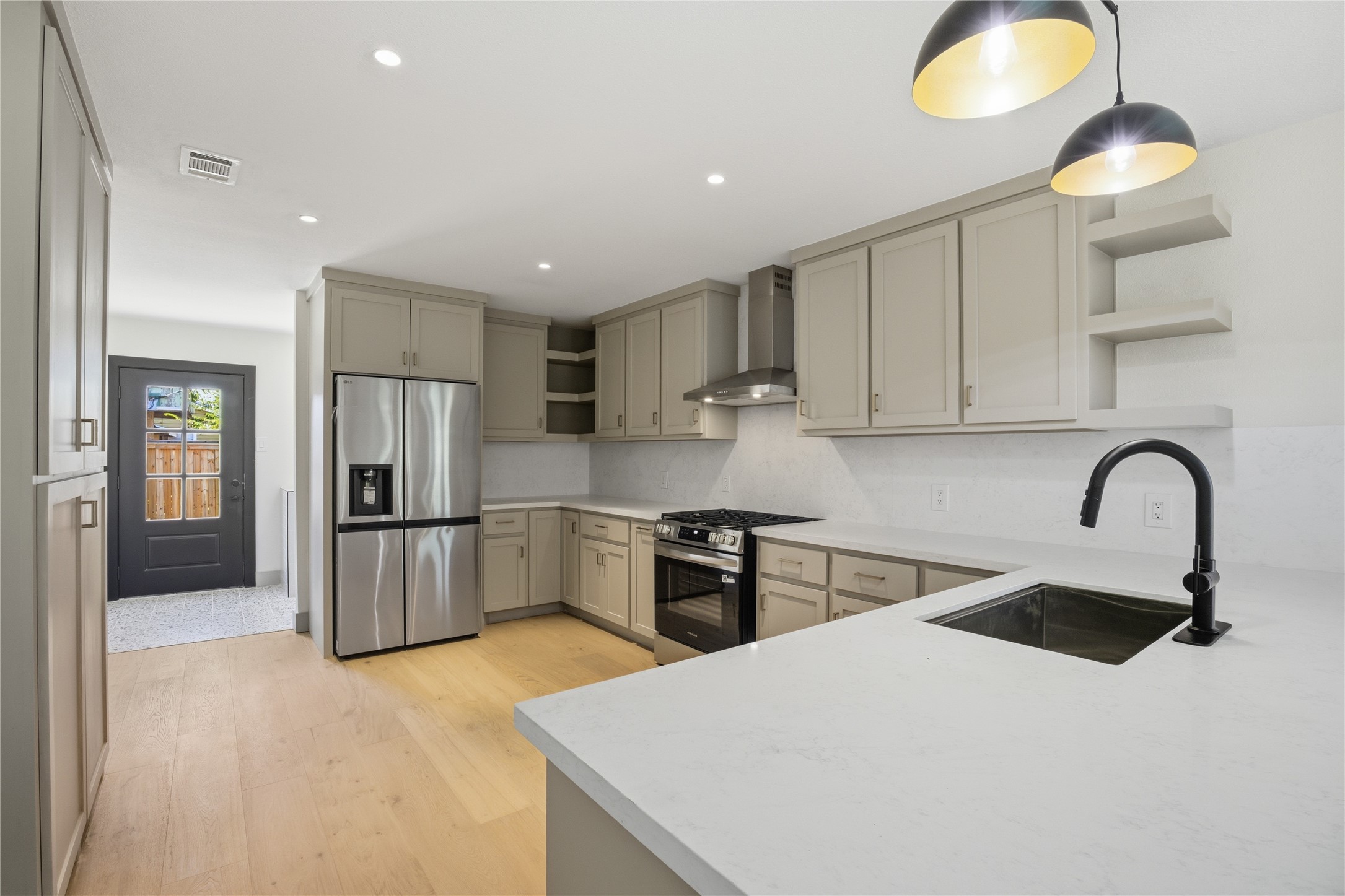 1415 Tabor Street Houston, TX 77009 - Photo 11 of 31 a kitchen with stainless steel appliances granite countertop a sink a stove a refrigerator cabinets and a dining table