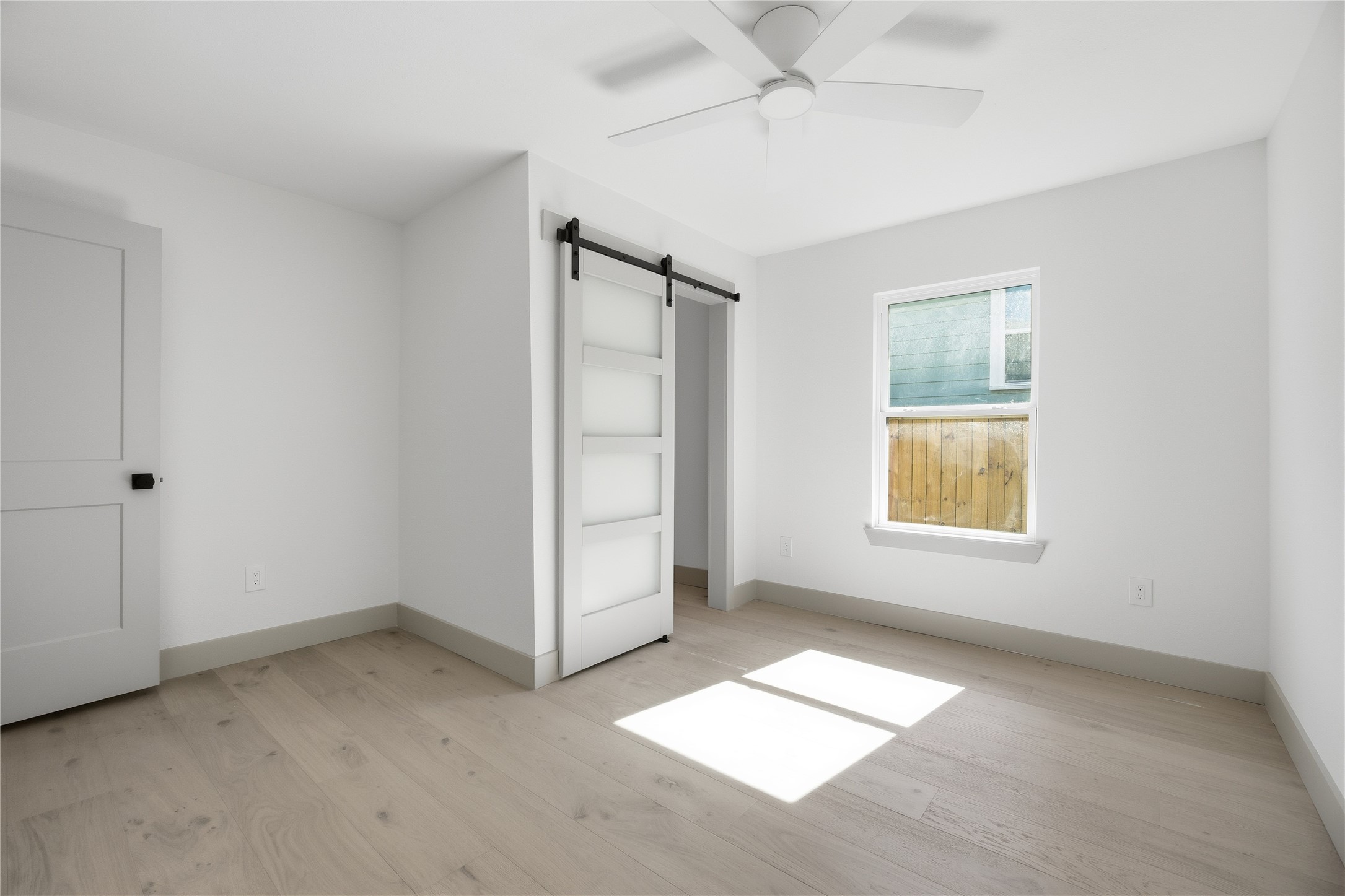 1415 Tabor Street Houston, TX 77009 - Photo 18 of 31 wooden floor in an empty room with a window