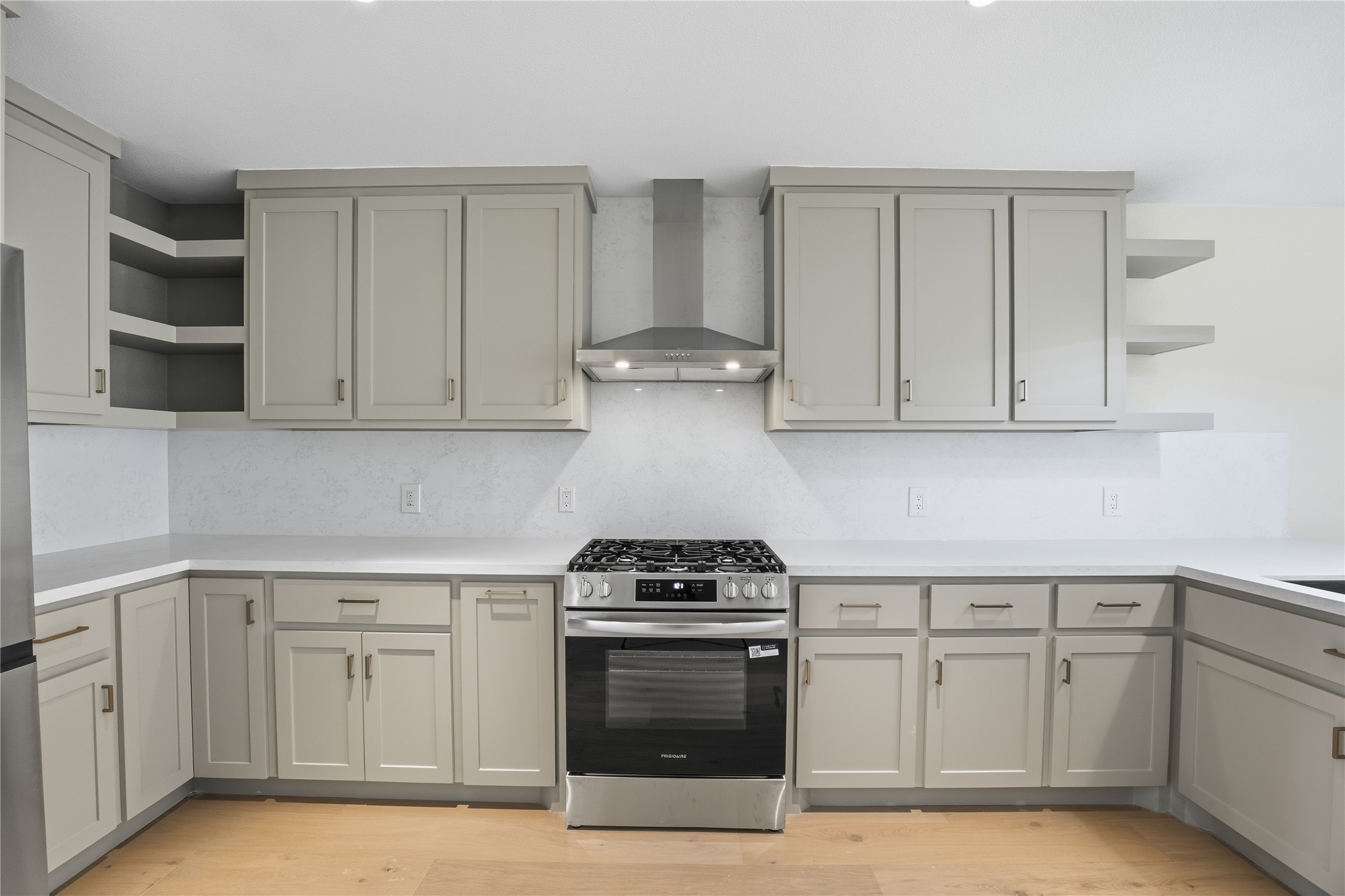 1415 Tabor Street Houston, TX 77009 - Photo 8 of 31 a kitchen with white cabinets and a stove