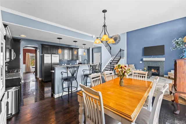 a dining room with furniture a chandelier and wooden floor